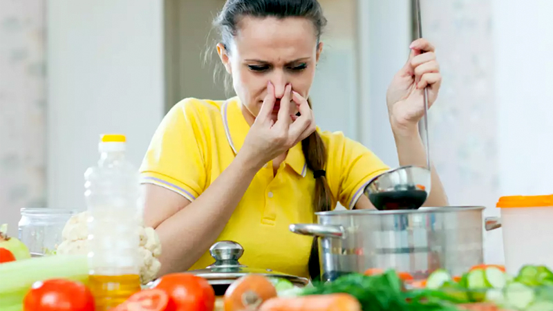 Woman reacting to bad kitchen smell