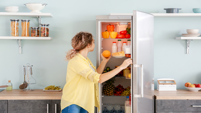 woman opening fridge