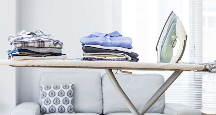 Ironing board with clothes on top