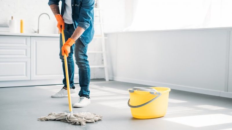 Man mopping the kitchen floor