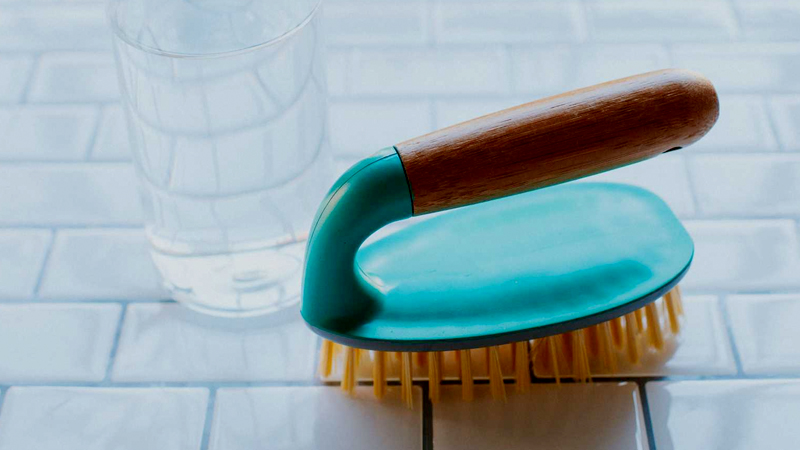 Grout cleaning with a brush