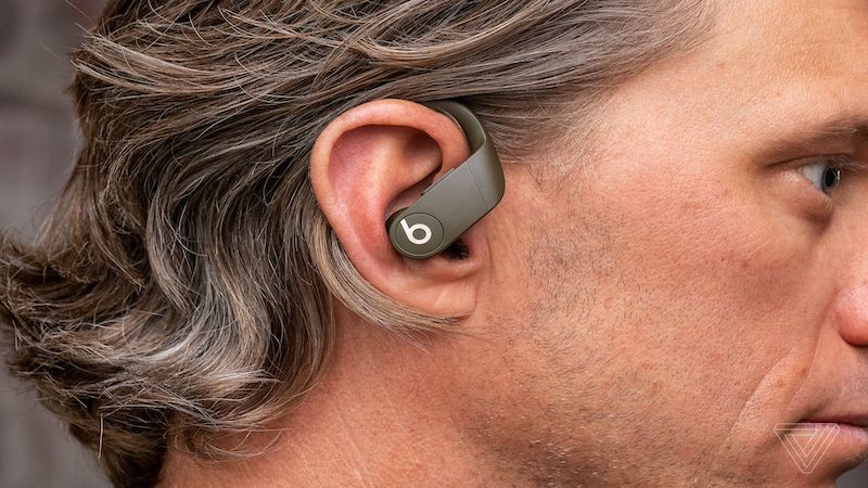 Man with behind the ear bluetooth headset