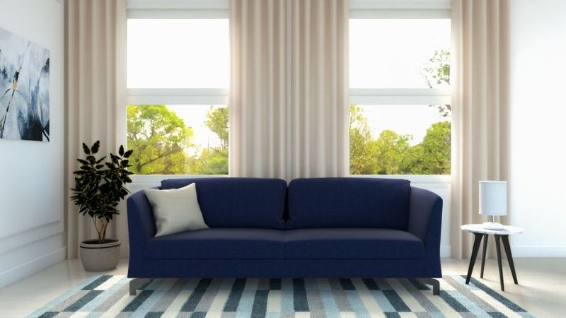 Neutral living room decor with dark blue sofa