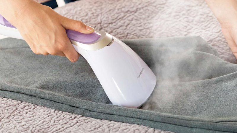 White handheld clothes steamer