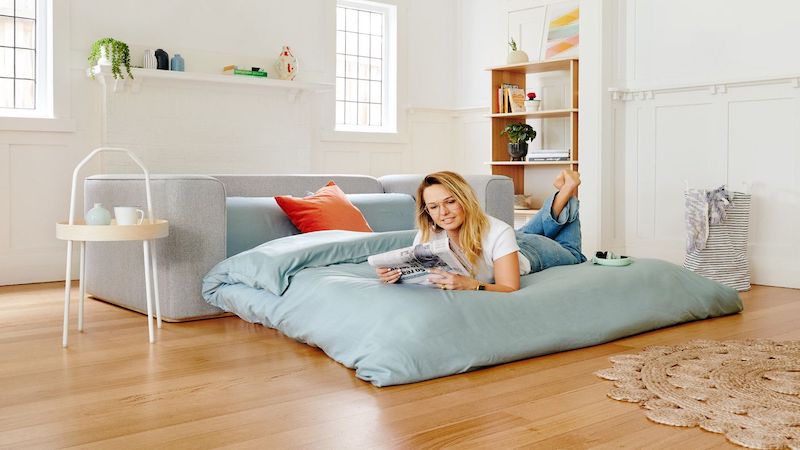 Woman lying on a sofa bed