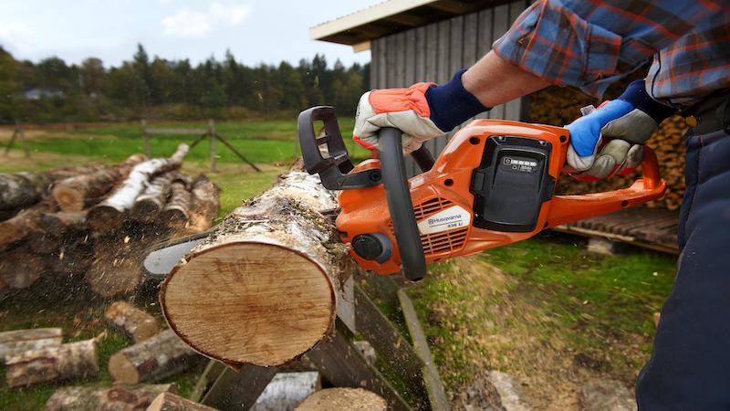 Man using electric chainsaw