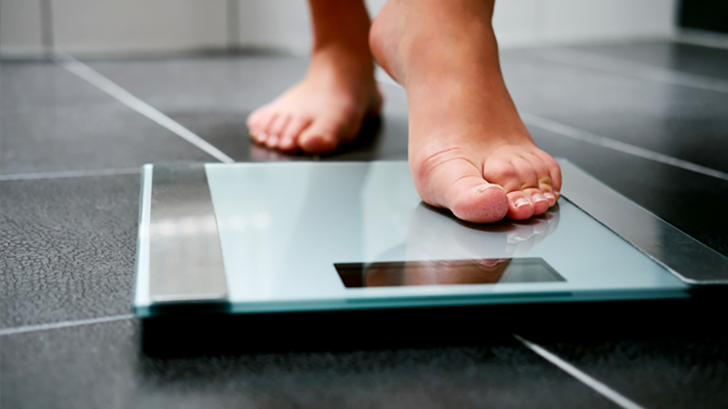 person stepping on scales
