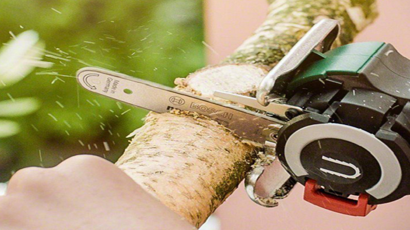 Portable chainsaw cutting wood