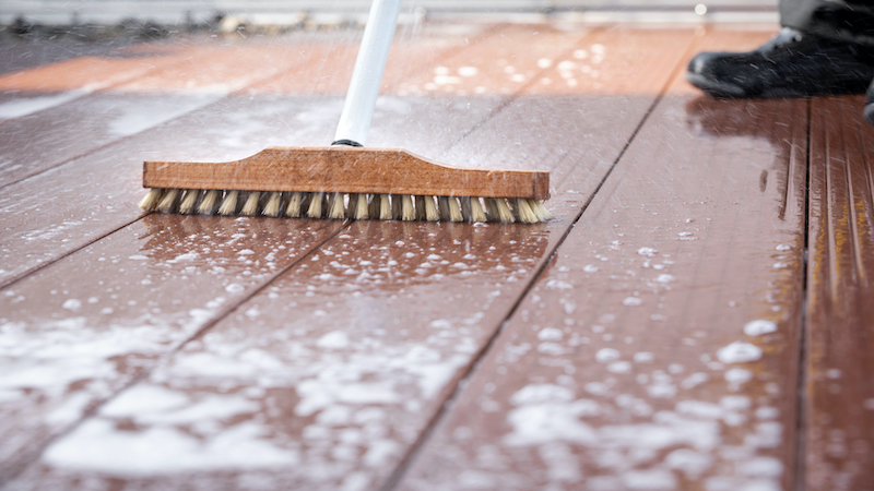 brush cleaning a patio